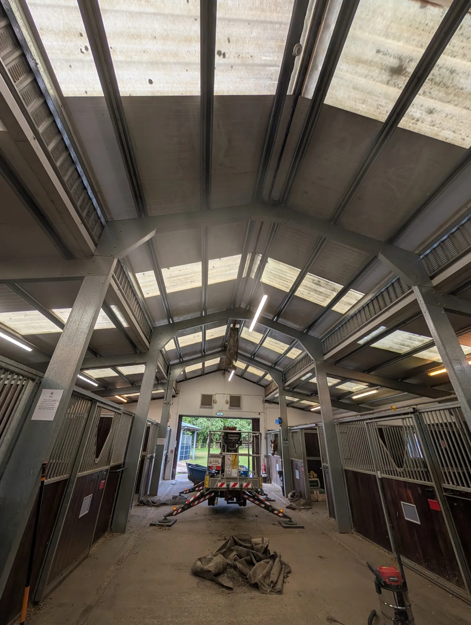 A LADS spider lift working on a long, low roof span — the kind of coverage we bring to Braintree's mill and industrial buildings